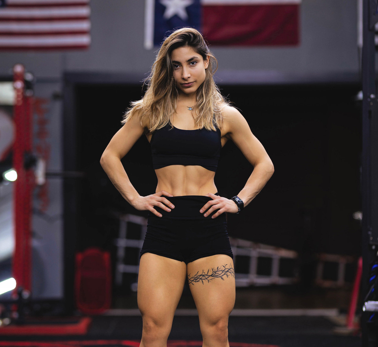 The coach is posing while wearing black clothing.